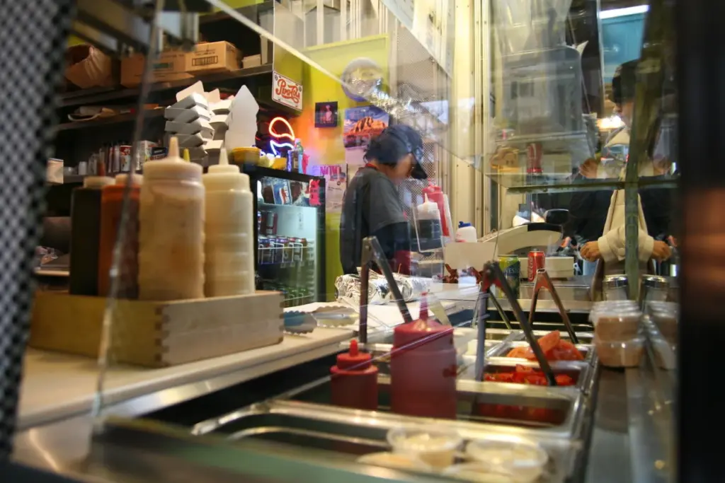 Restaurant worker behind the counter at a casual Toronto food spot