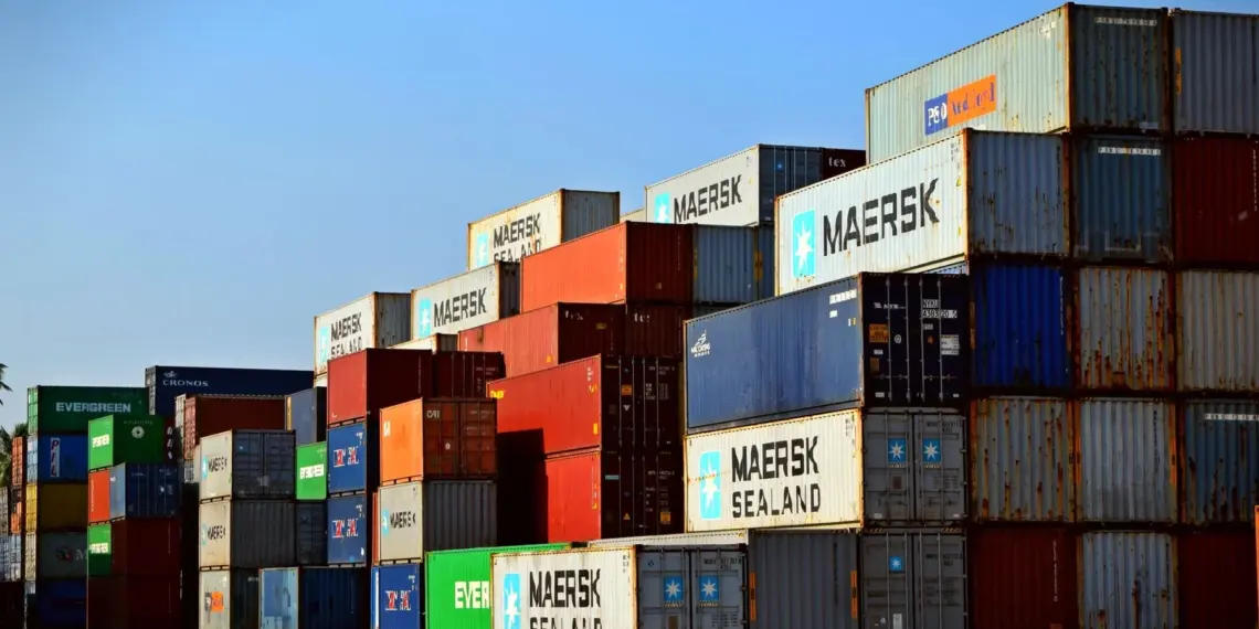 Rows of colourful shipping containers stacked at a freight terminal