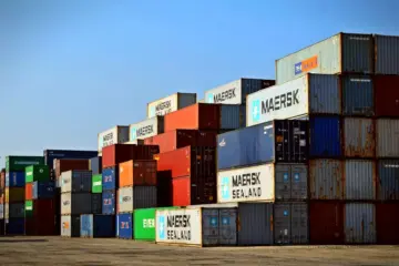 Rows of colourful shipping containers stacked at a freight terminal