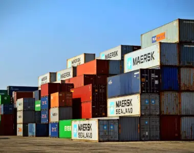 Rows of colourful shipping containers stacked at a freight terminal