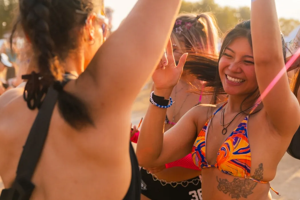 Two women dance in the afternoon sun at VELD Music Festival.