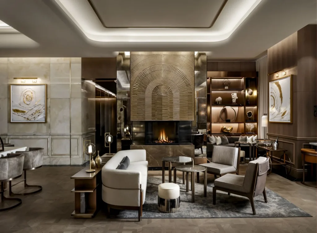 Tables and upholstered seats beside the fireplace in Astor Lounge