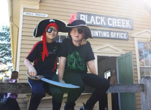 Two children wearing pirate costumes at the Village at Black Creek