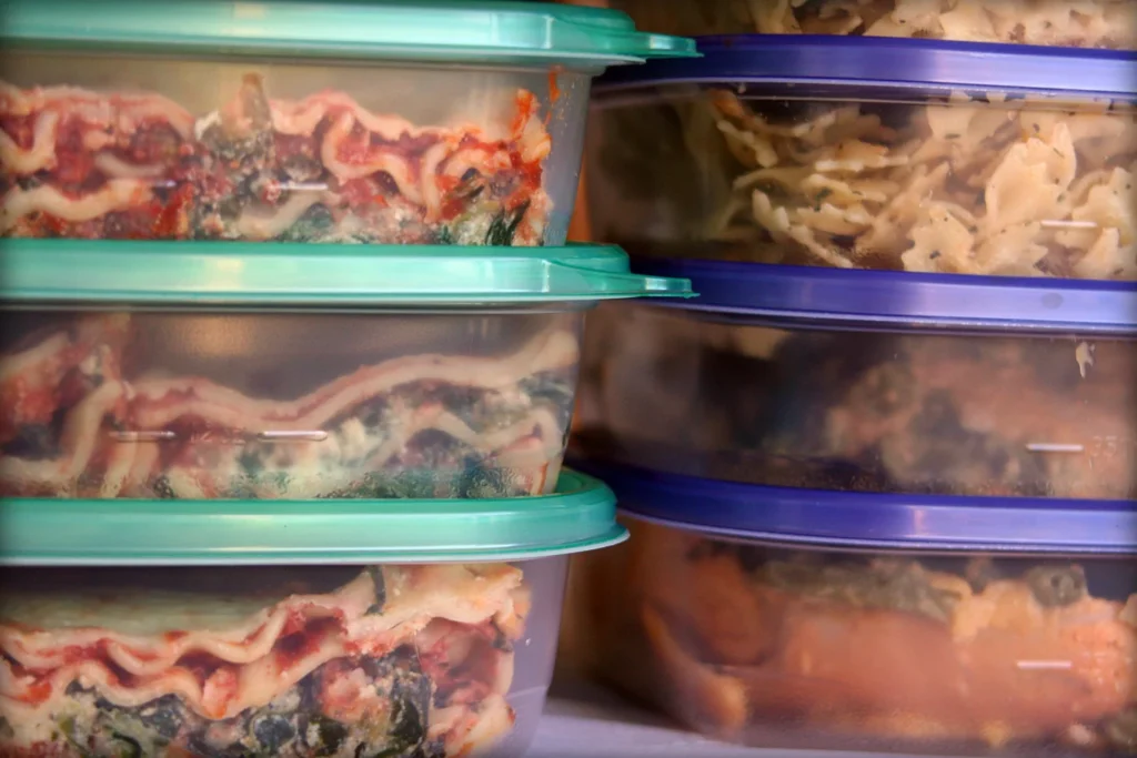 Cooked food divided among separate food storage containers