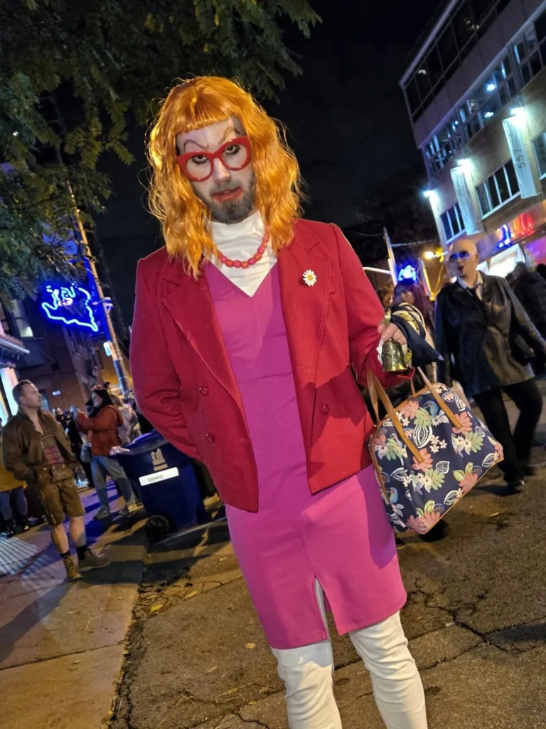 A visitor in a bright pink Aunt Gladys costume on Church Street