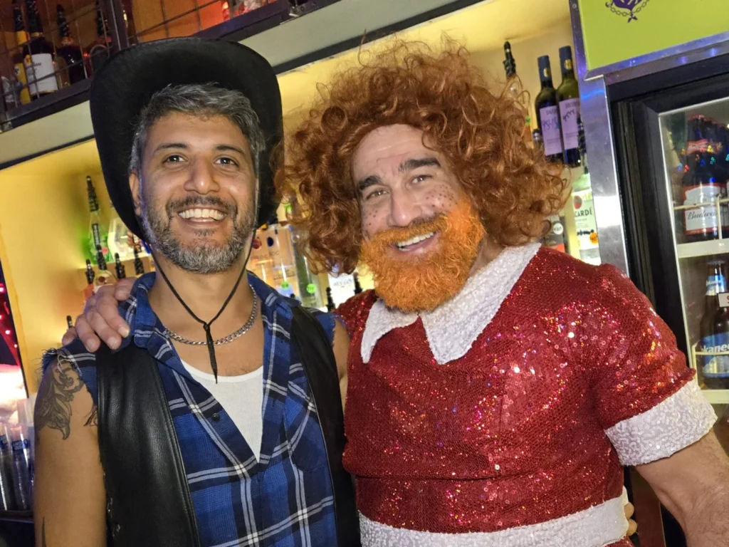 Two visitors in colourful character costumes during the 2025 Village Halloween celebration