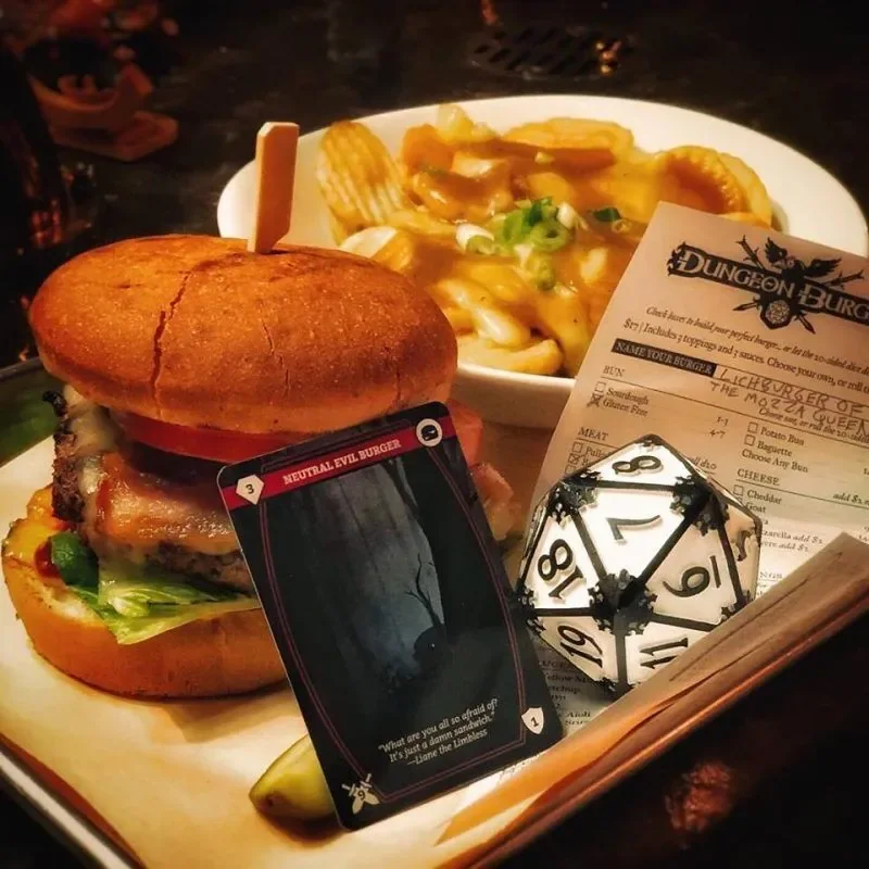 A burger, fries and game-themed table details at Storm Crow Manor