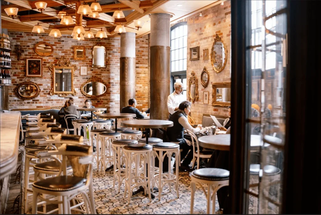 Tables and tall windows inside Cluny Bistro in the Distillery District