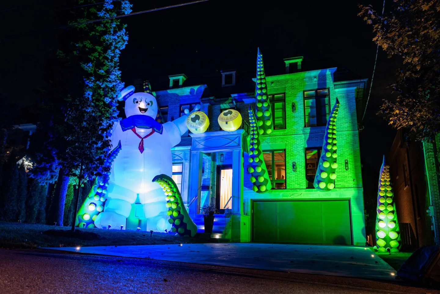 A Toronto house with green lighting, giant tentacles and a Stay Puft figure