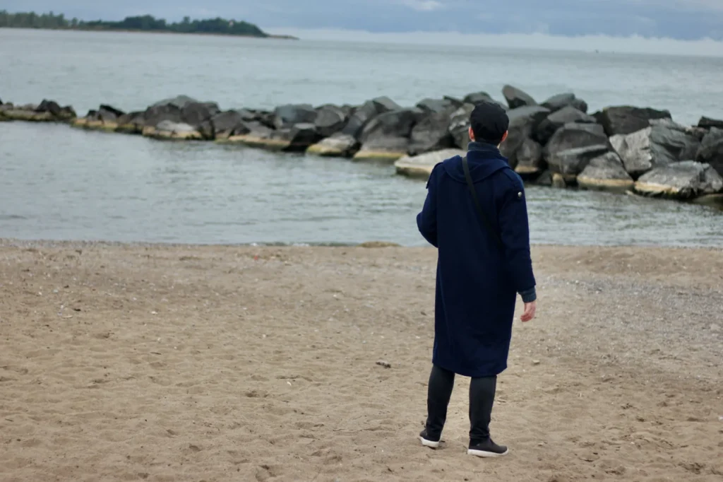 A Haunted Harbour guide standing on a beach beside Lake Ontario