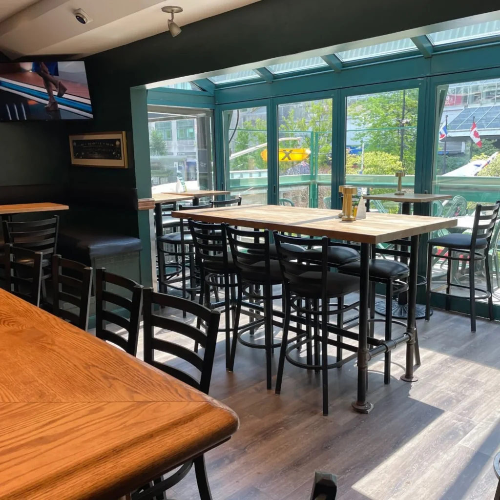 Covered seating beside large windows at Hemingway’s