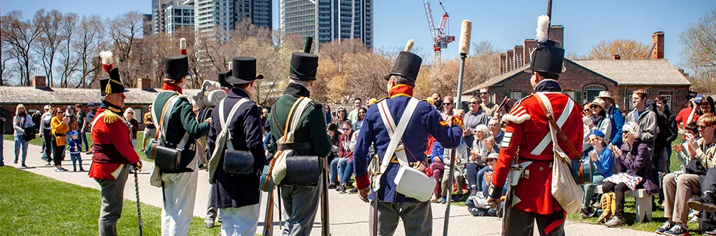 Historical interpreters in military uniforms at Fort York