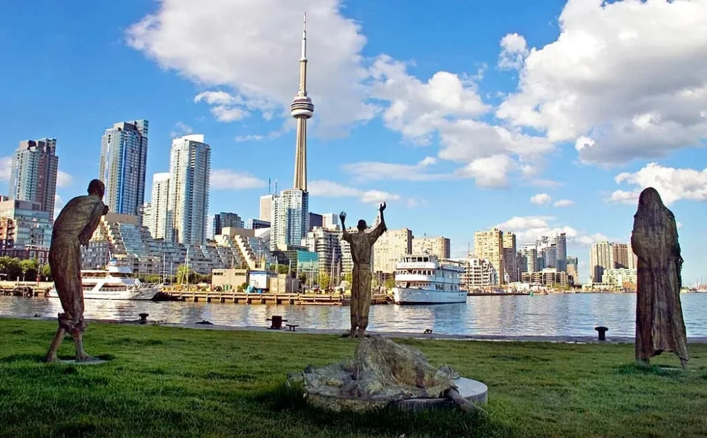 Ireland Park memorial figures with Toronto skyline behind