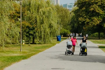 People walking on a paved path on Toronto Island
