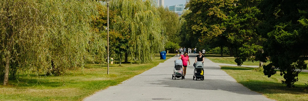 People walking on a paved path on Toronto Island