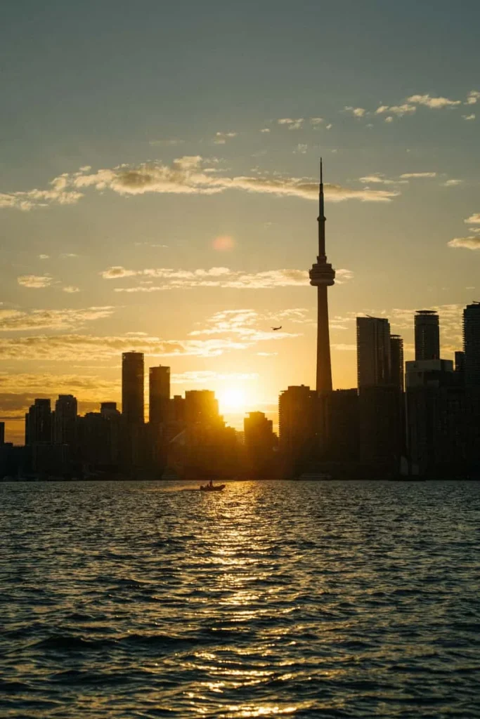 The CN Tower and Toronto skyline across the harbour at sunset