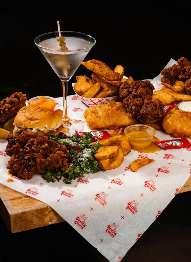Burgers, fries and small dishes on a tray at Chefs Hall