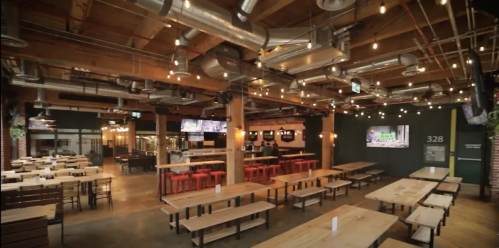 Communal tables and television screens at Left Field Brewery in Liberty Village