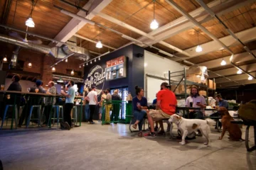 People and dogs in the original Left Field Brewery taproom in Leslieville