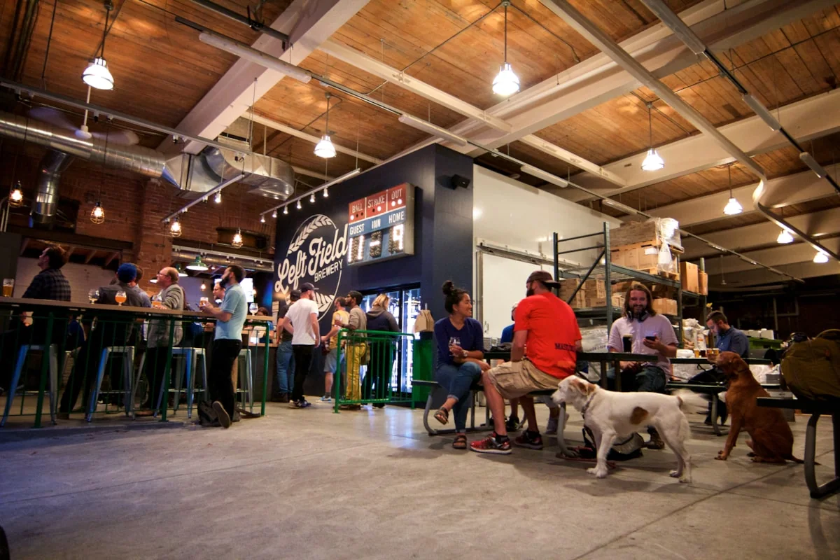 People and dogs in the original Left Field Brewery taproom in Leslieville