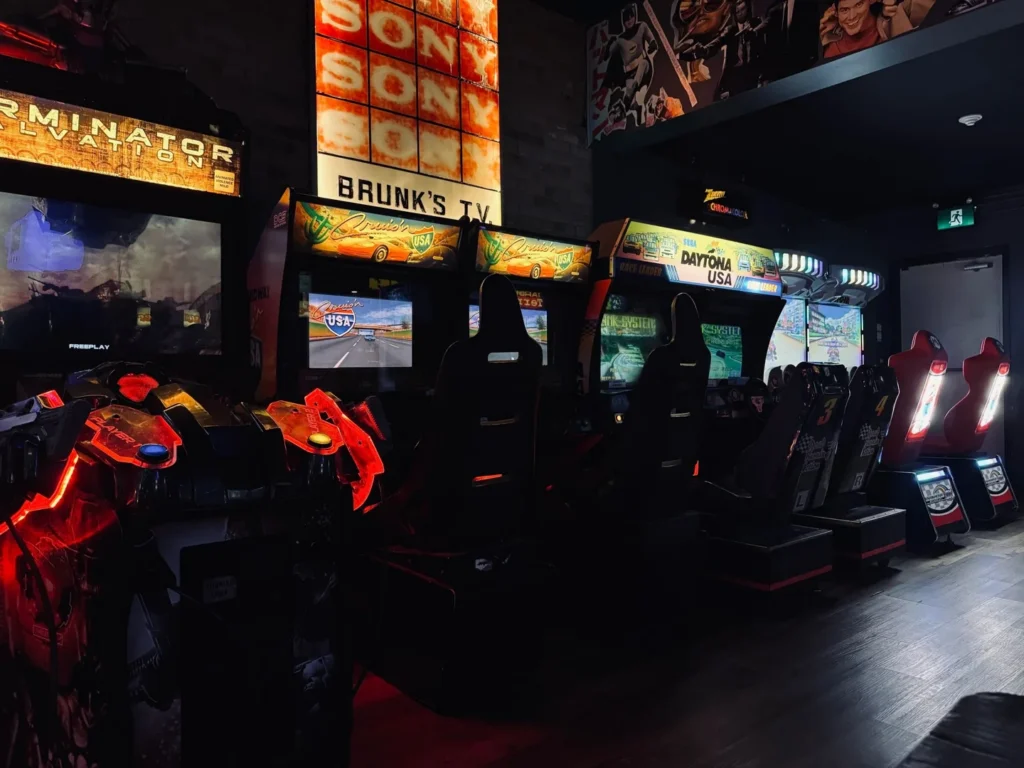 Rows of lit arcade cabinets inside Tilt Toronto