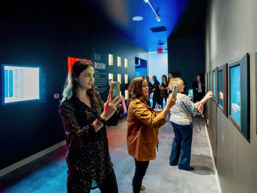 Visitors making coloured shadows in the Museum of Illusions Toronto