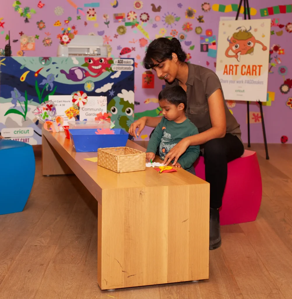 An adult and child making art together at the AGO Art Cart