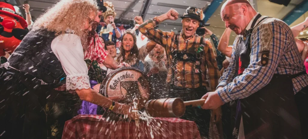 People gathered around a keg at Concordia Club Oktoberfest