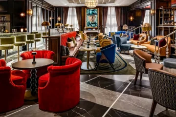 Red chairs and dark wood inside Library Bar at Fairmont Royal York