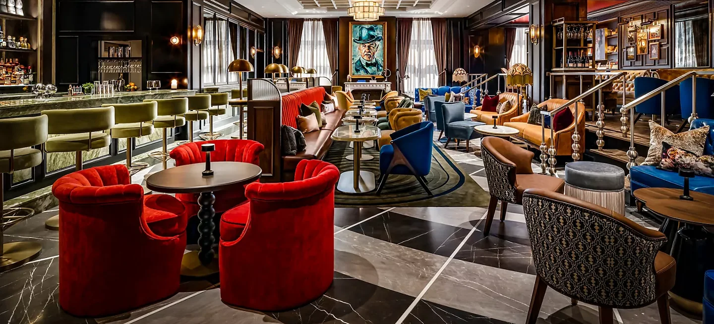 Red chairs and dark wood inside Library Bar at Fairmont Royal York