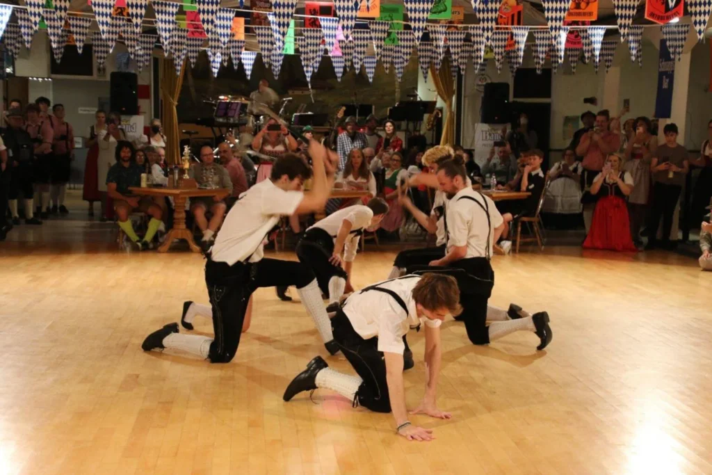 Alpine Club dancers performing inside a decorated hall