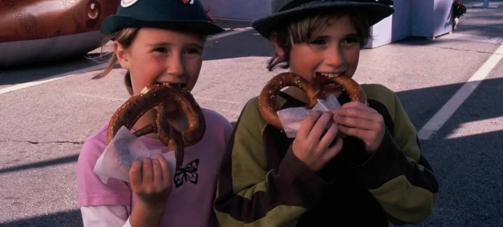 Two children eating pretzels at a past Oktoberfest event