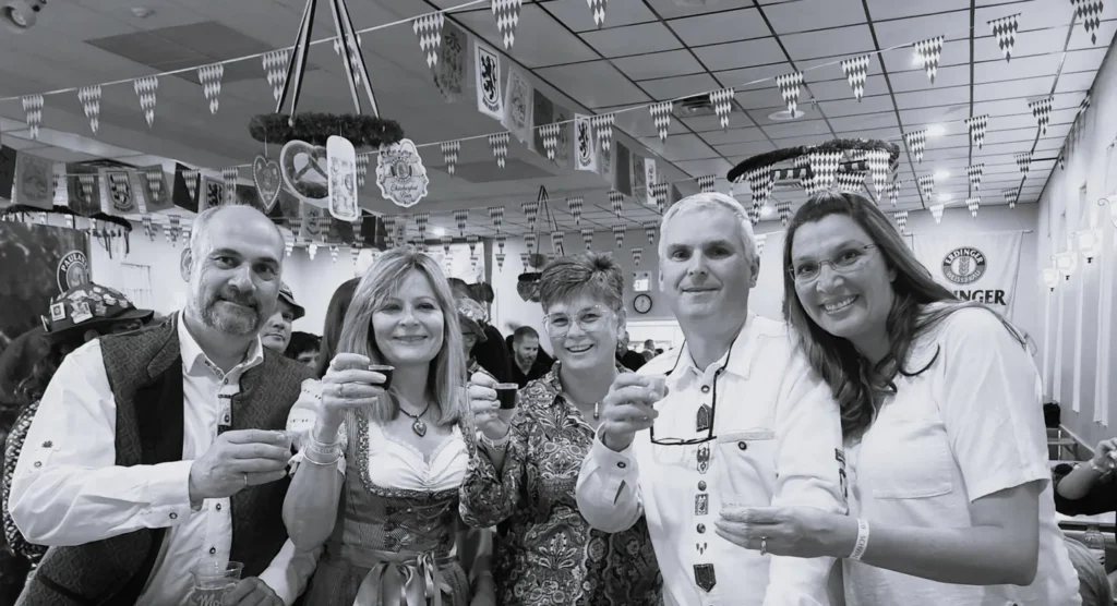 A group raising small glasses at the Schwaben Club