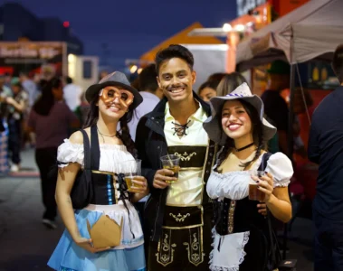 Three visitors dressed for Toronto Oktoberfest