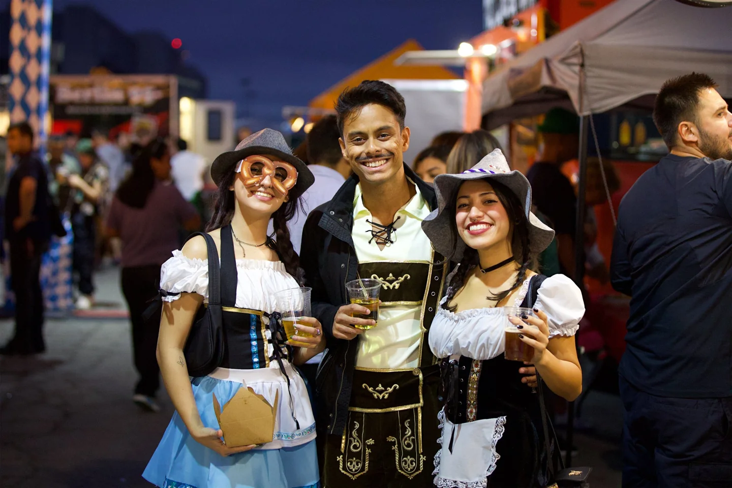 Three visitors dressed for Toronto Oktoberfest