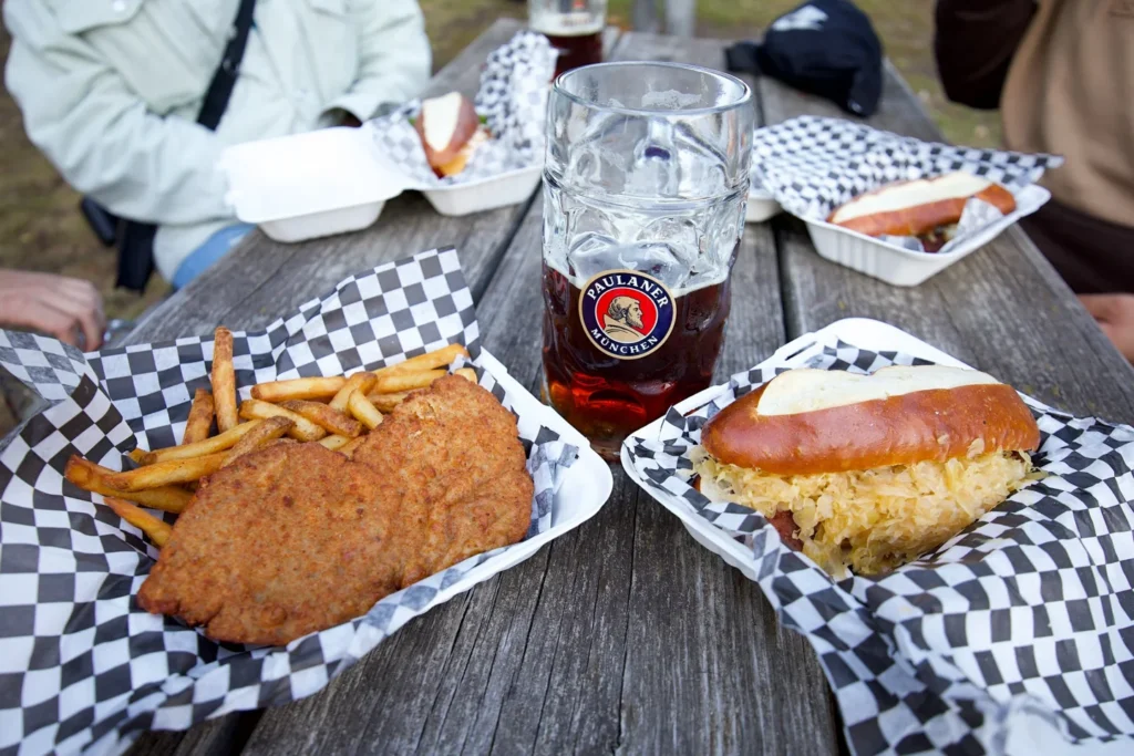 Schnitzel, sausage and drinks on a table at Toronto Oktoberfest
