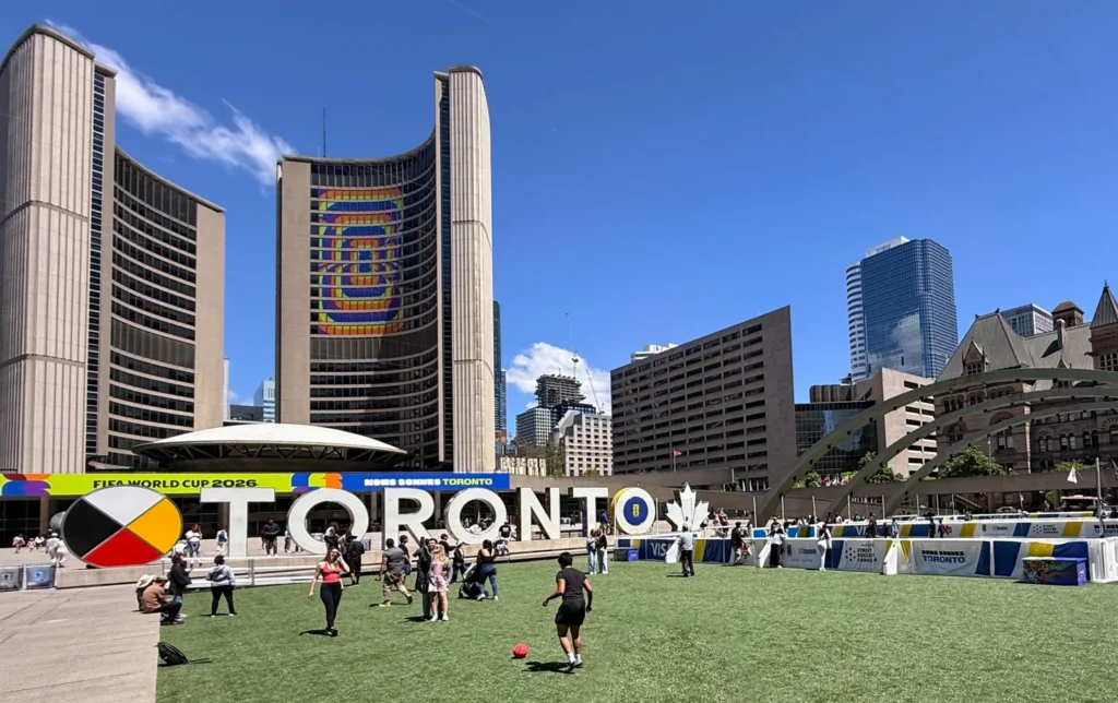 Toronto City Hall and people on Nathan Phillips Square in May 2026