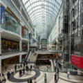 Shoppers on several levels beneath the glass roof at Toronto Eaton Centre