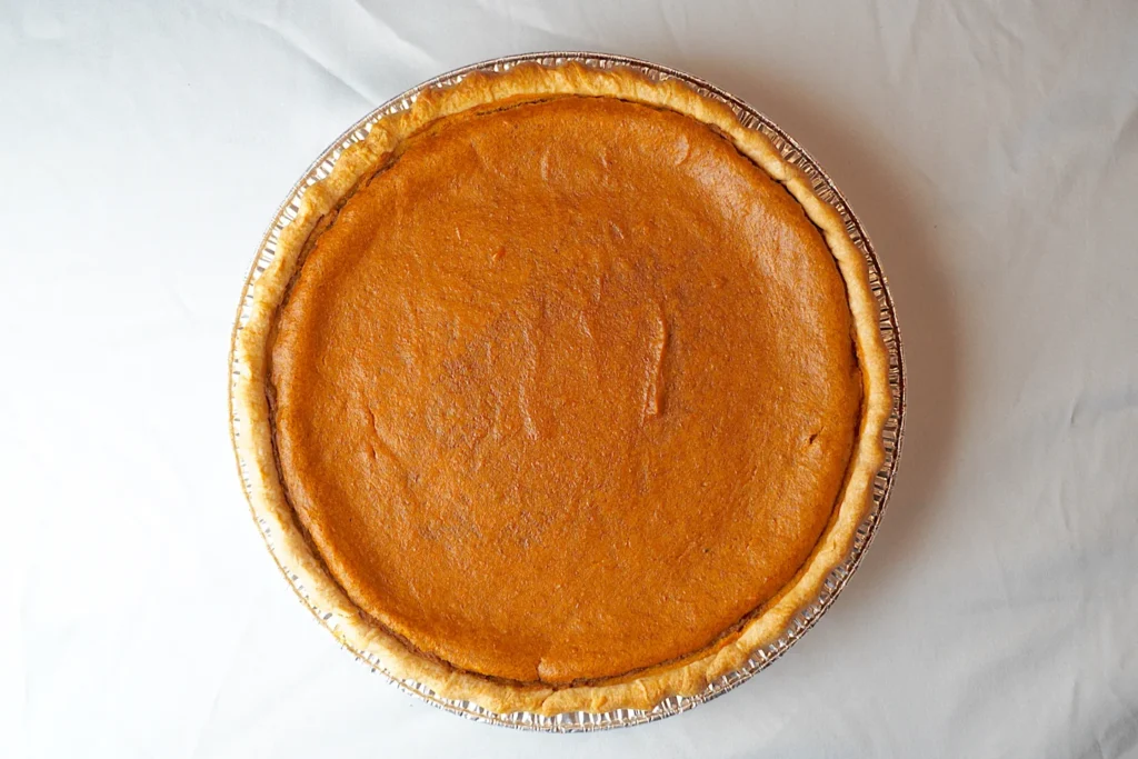 A whole pumpkin pie photographed from above