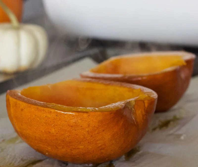 Roasted pumpkin halves on a baking surface
