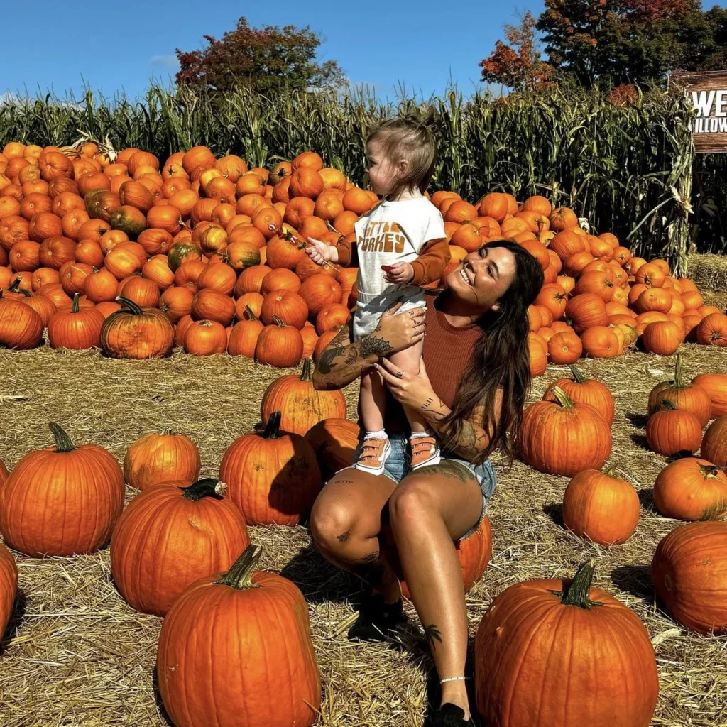 A child carrying a pumpkin across Willowtree Farm’s pumpkin yard