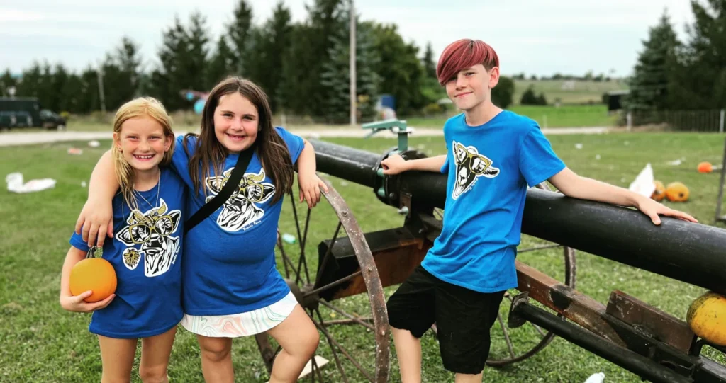 Children beside the animal enclosure at Brooks Farms