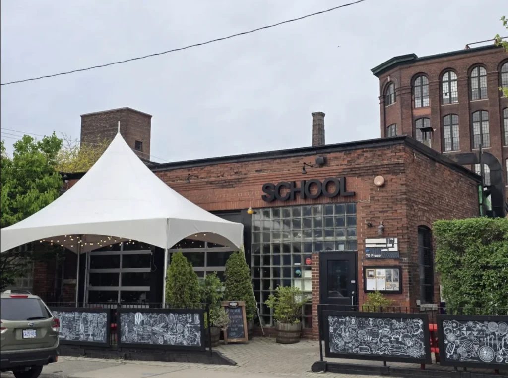 SCHOOL Restaurant with its outdoor tables and awnings on Fraser Avenue