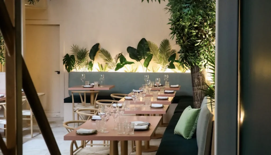 Tables and plants on the sheltered back patio at Bar Reyna