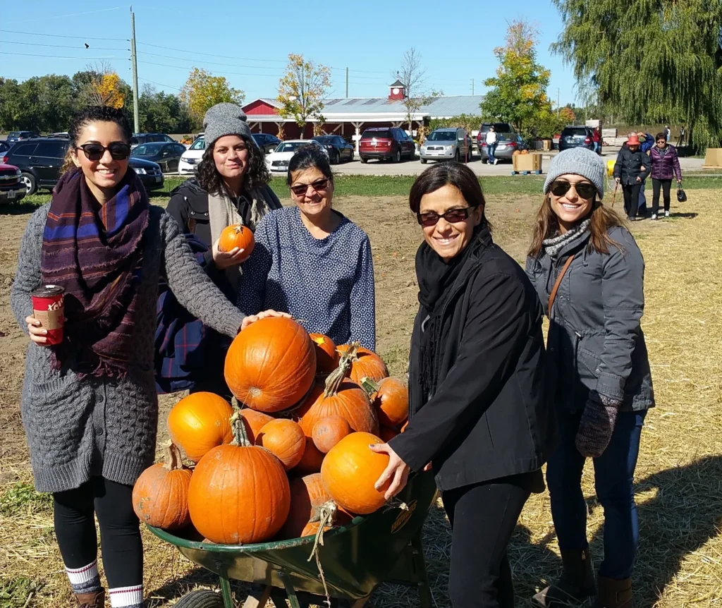 Visitors holding pumpkins at Reesor’s Farm Market