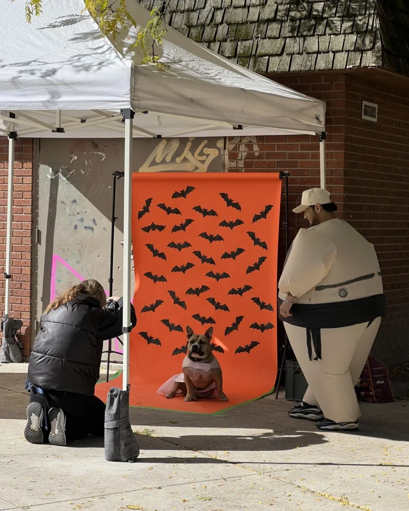 A visitor standing beside the Halloween photo booth at Riverside’s festival