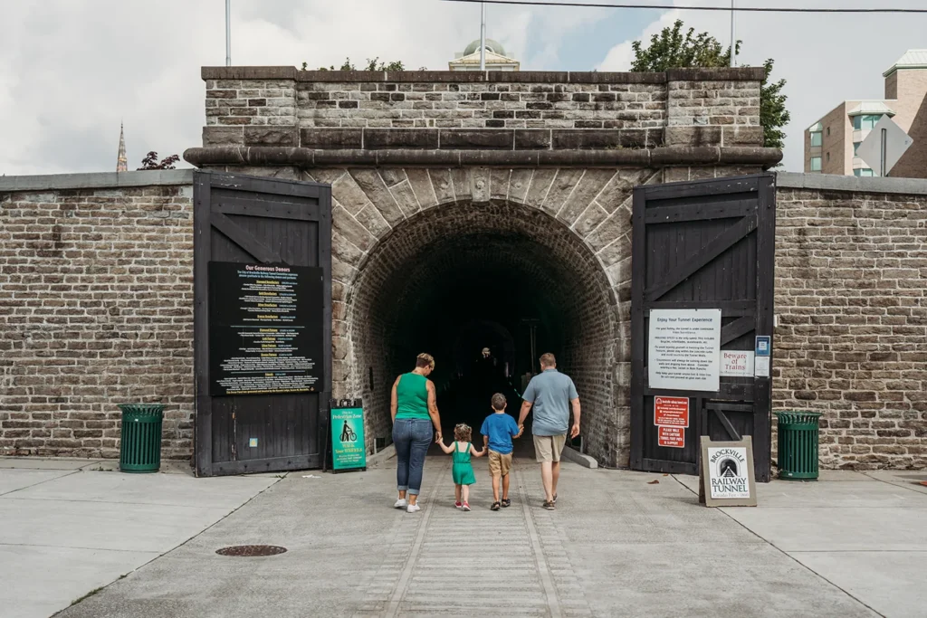 Visitors entering the stone south portal of Brockville railway tunnel
