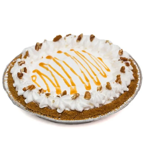 Pumpkin pie topped with cream, caramel and pecans