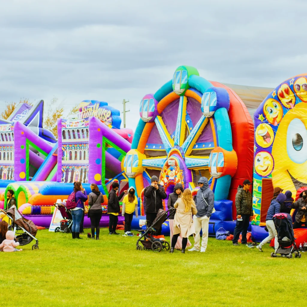 Families beside colourful inflatable attractions at PumpkinFest Toronto