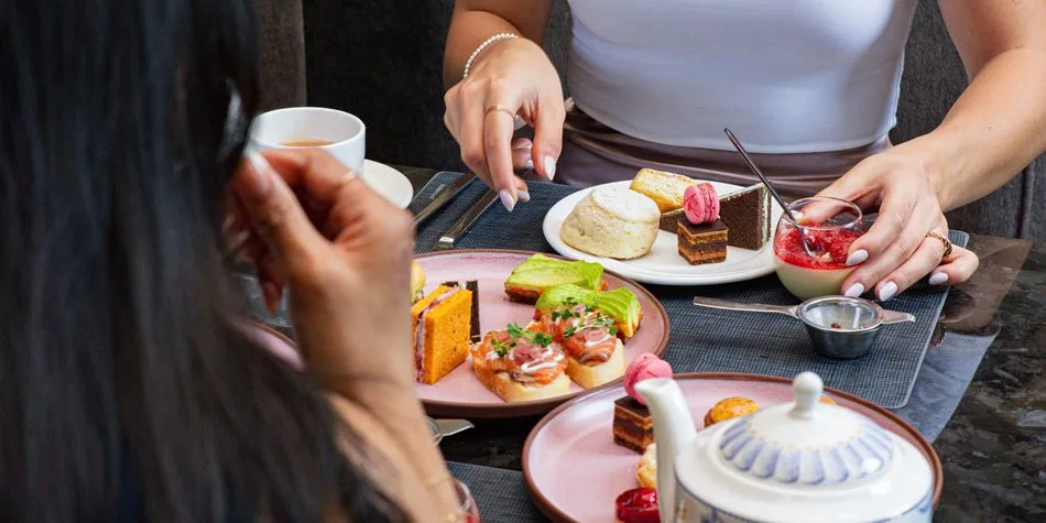 Guests sharing sandwiches, pastries and tea at Azure in downtown Toronto